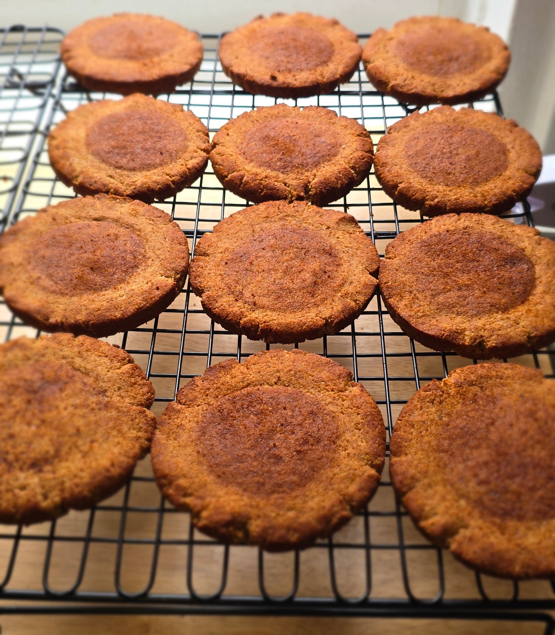 12 Cinnamon sugar coated baked cookies on a cooling rack